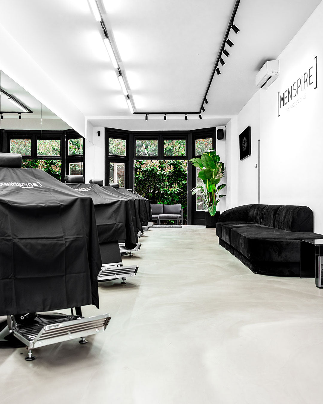 MENSPIRE salon reflecting the brand’s innovative approach to men’s grooming, featuring contemporary design, expert barbers, and a focus on delivering a luxury grooming experience