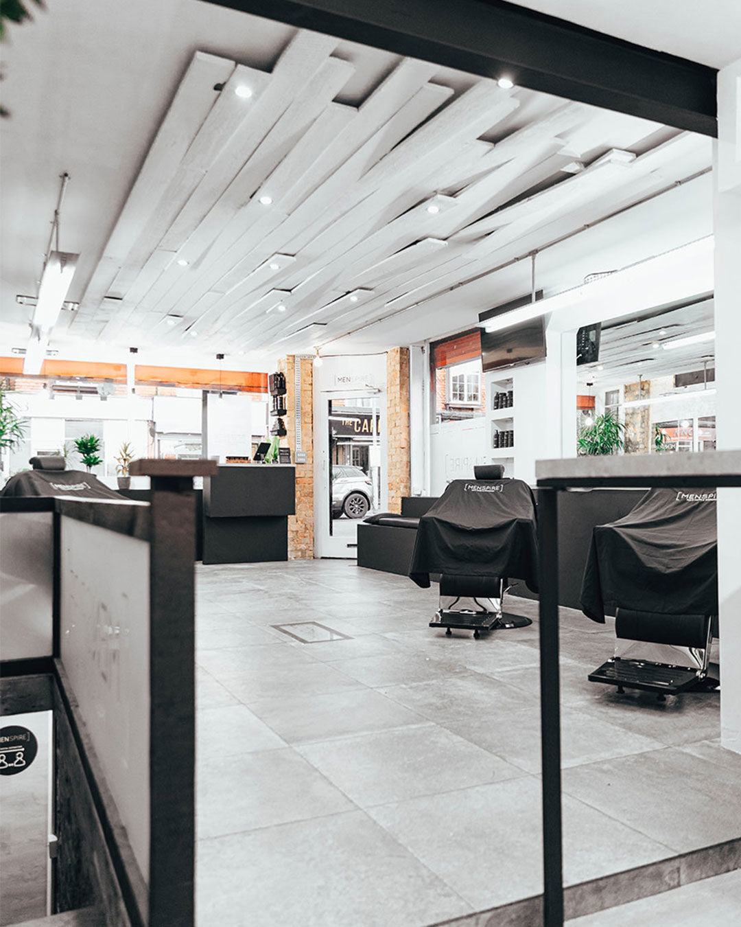MENSPIRE salon reflecting the brand’s innovative approach to men’s grooming, featuring contemporary design, expert barbers, and a focus on delivering a luxury grooming experience
