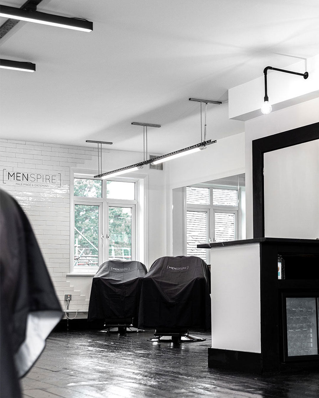 MENSPIRE salon reflecting the brand’s innovative approach to men’s grooming, featuring contemporary design, expert barbers, and a focus on delivering a luxury grooming experience
